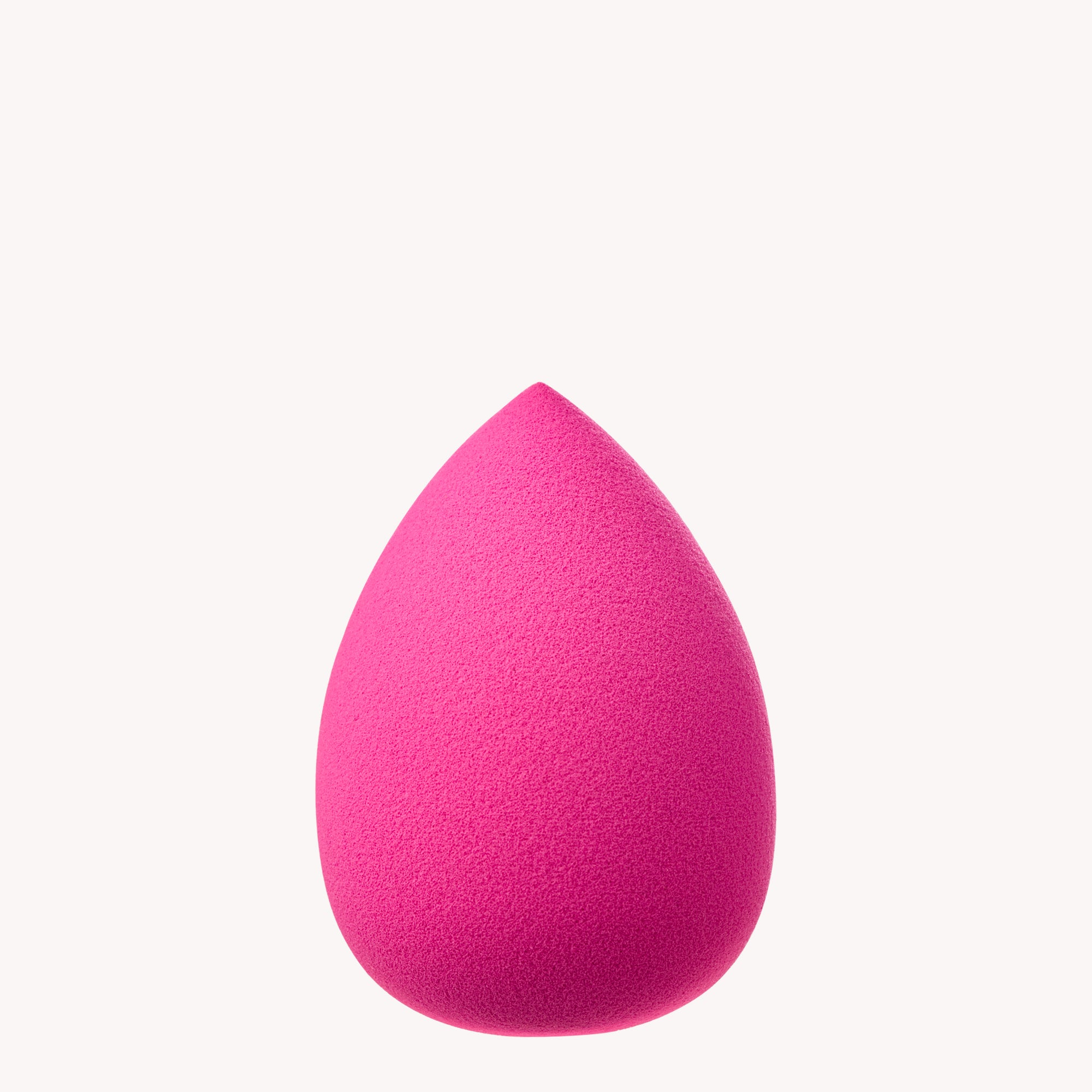 Pink makeup sponge on a white background