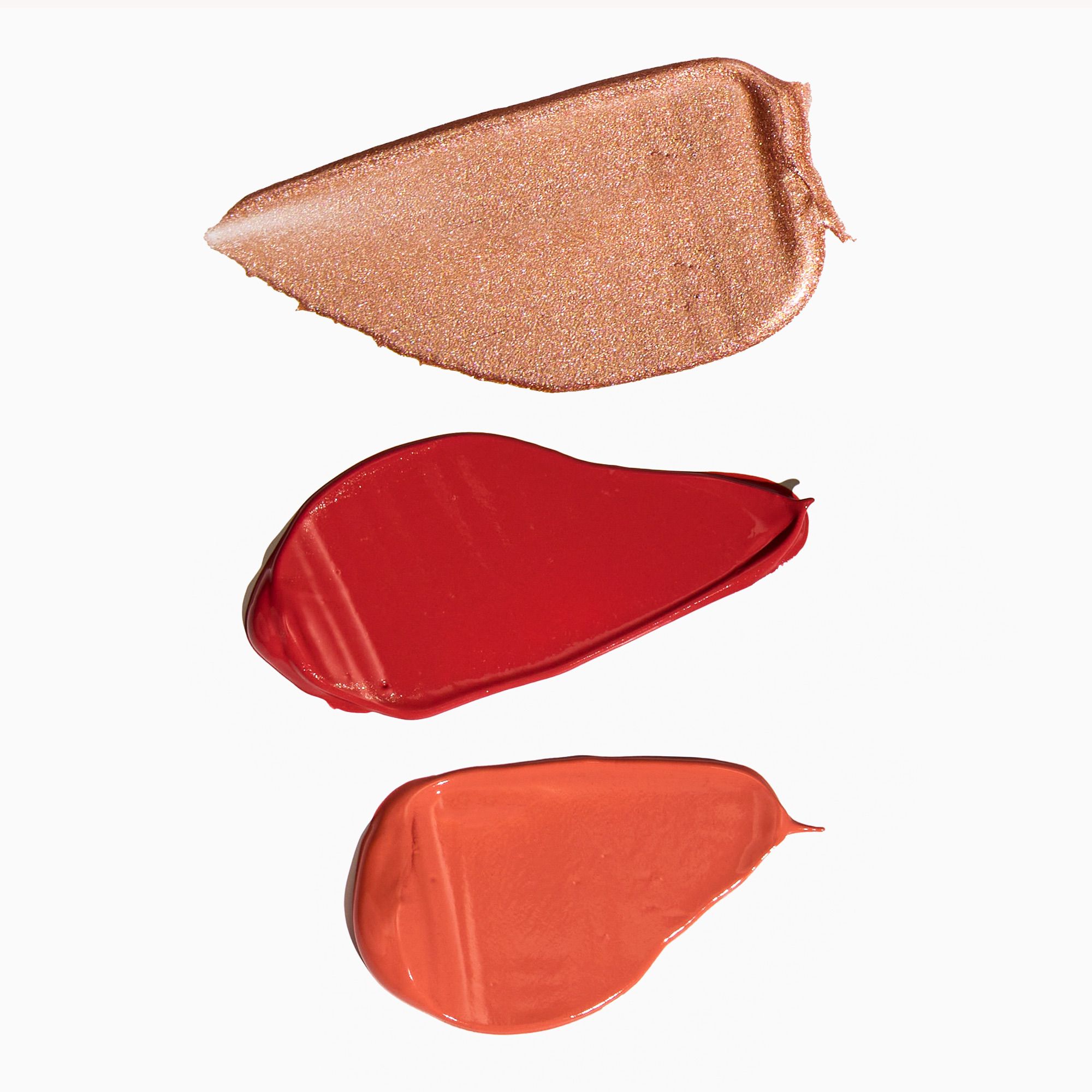 Three swatches of different lip colors on a white background