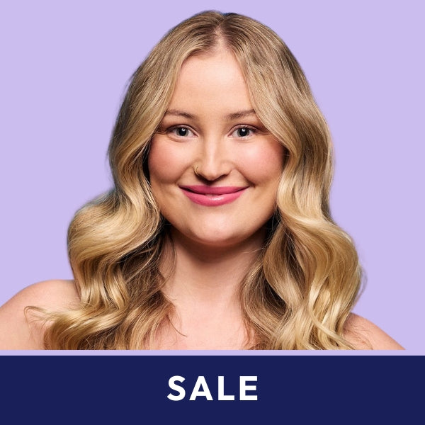 Smiling woman with wavy blonde hair on a light purple background. A dark blue banner at the bottom reads "SALE" in white text.
