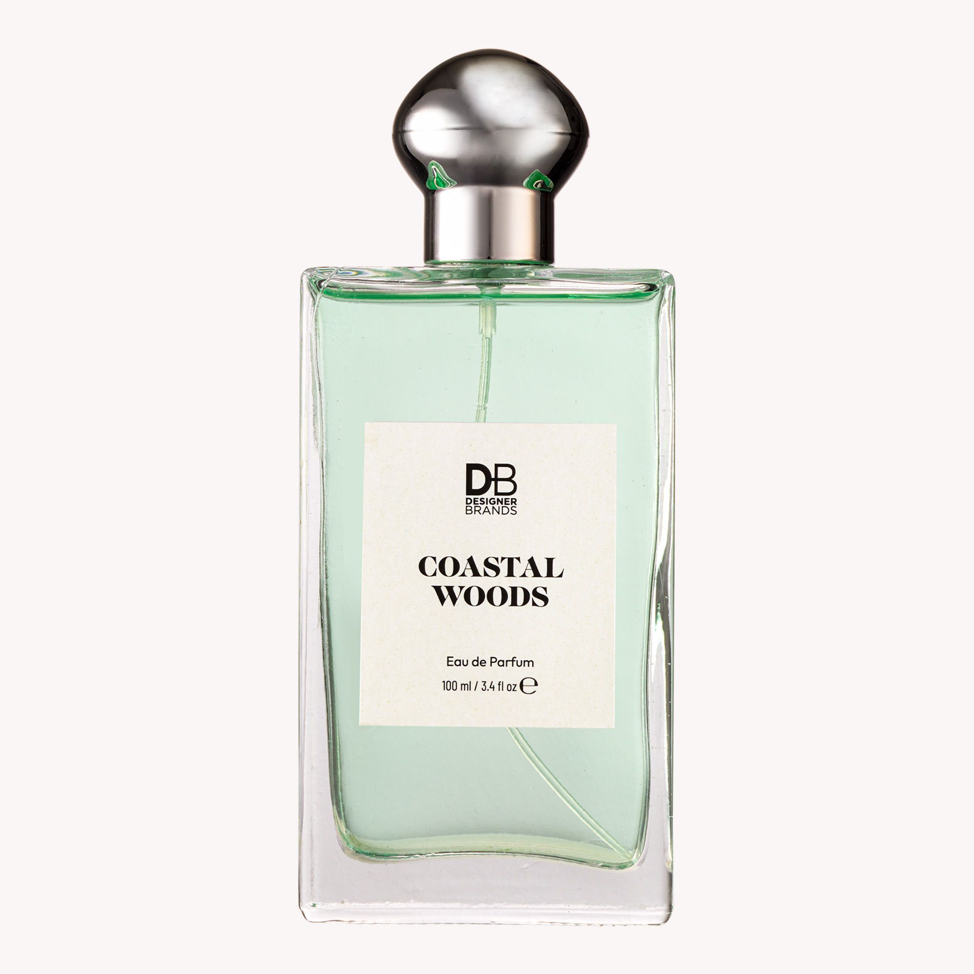 Perfume bottle labeled 'Coastal Woods' by DB on a white background