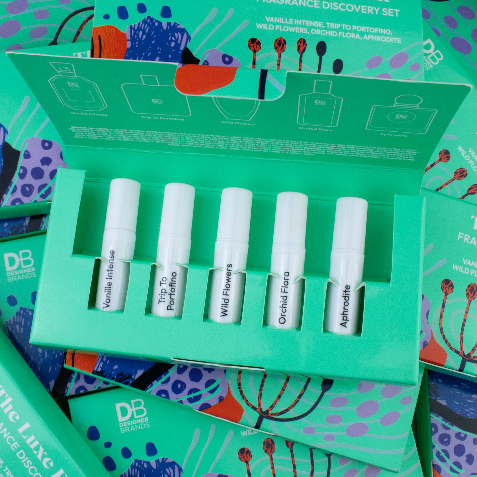 Set of six small white bottles in a green box with branding on a colorful background