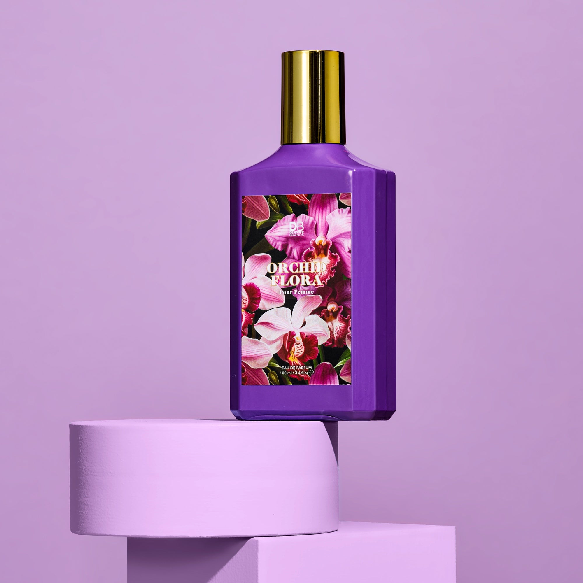 Purple perfume bottle with floral design on a purple background