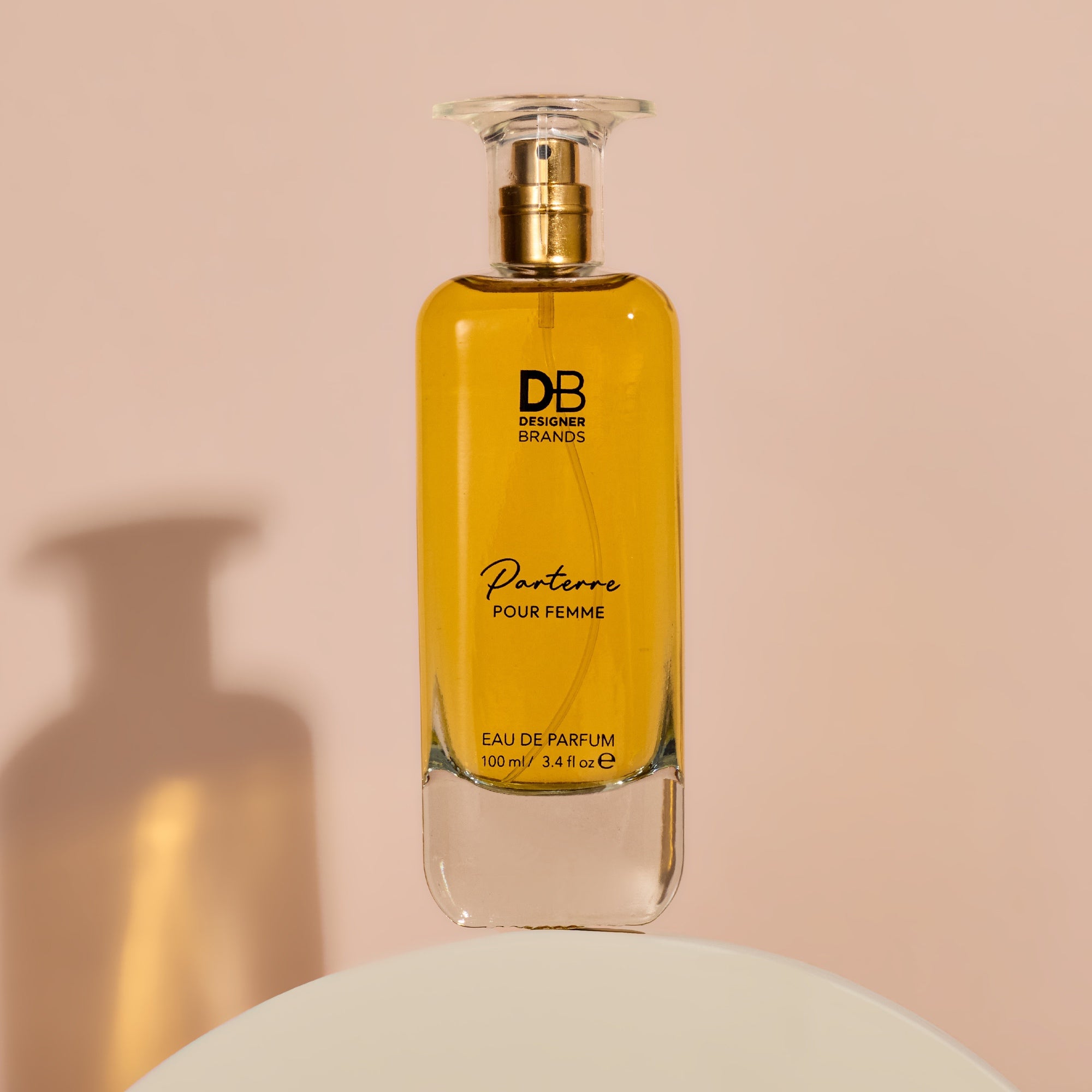 Perfume bottle labeled 'DB Designer Brands Parterre Pour Femme' on a beige background