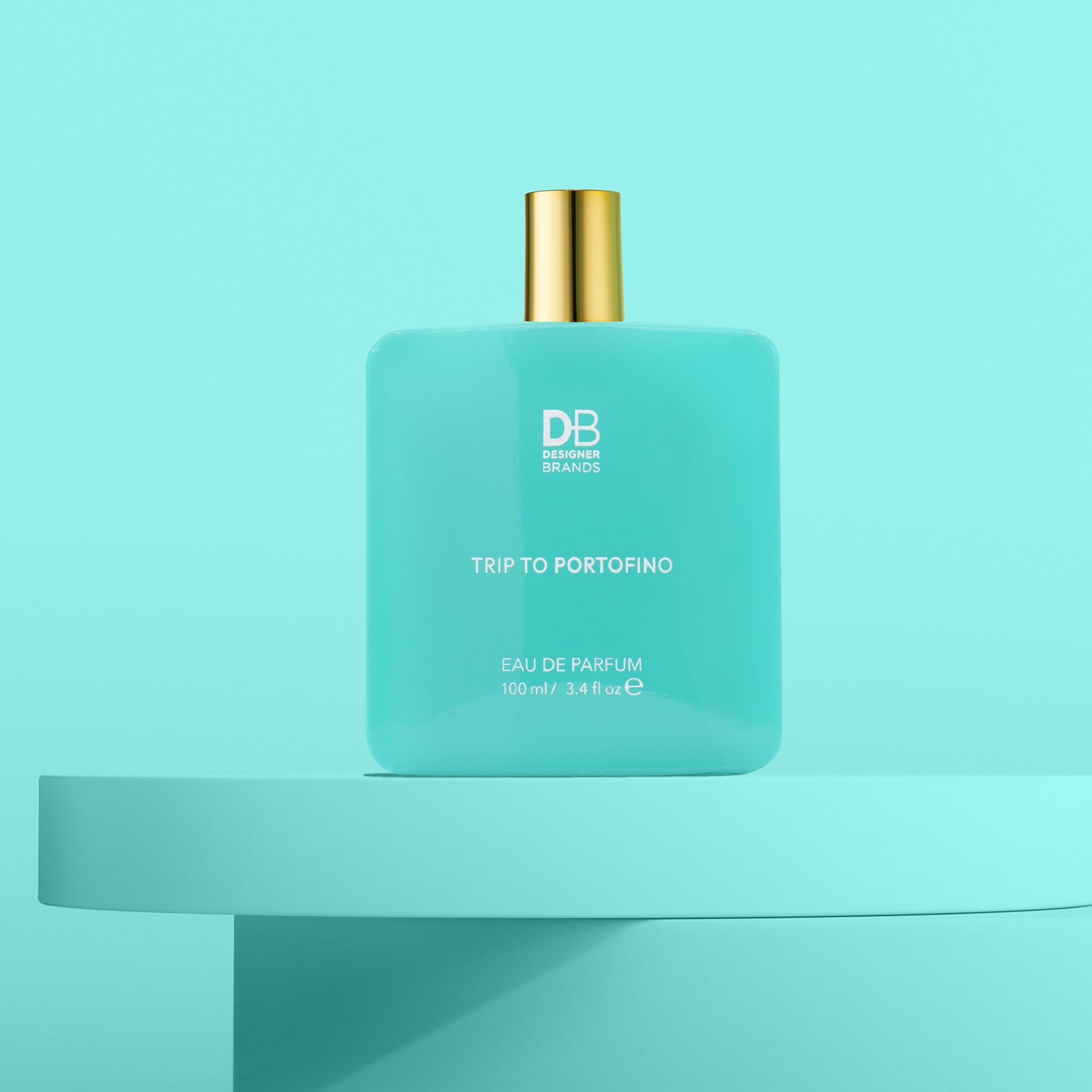 Turquoise perfume bottle with gold cap on a light blue background