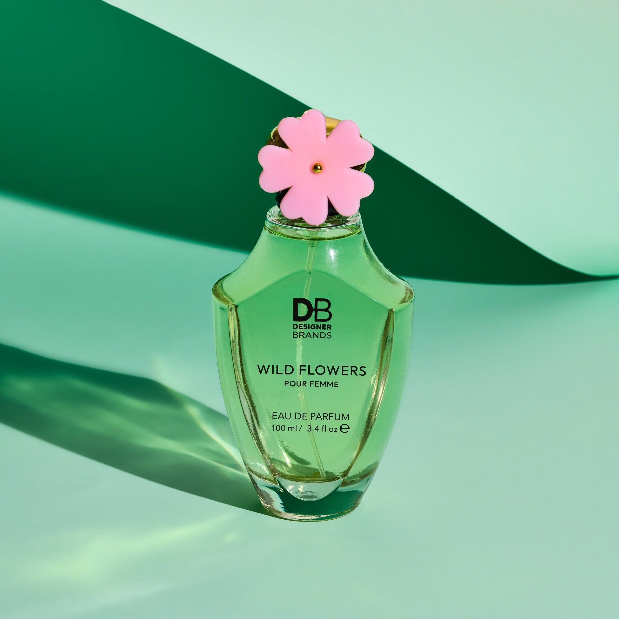 Green perfume bottle labeled 'Wild Flowers' with a pink flower on a green background
