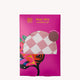 Pink packaging of a Stay Dry shower cap with a pink checkered pattern and microfibre lining. Design features vibrant abstract art.