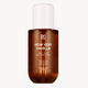 Brown bottle of 'How Very Vanilla' hair and body fragrance mist with a white cap on a white background.