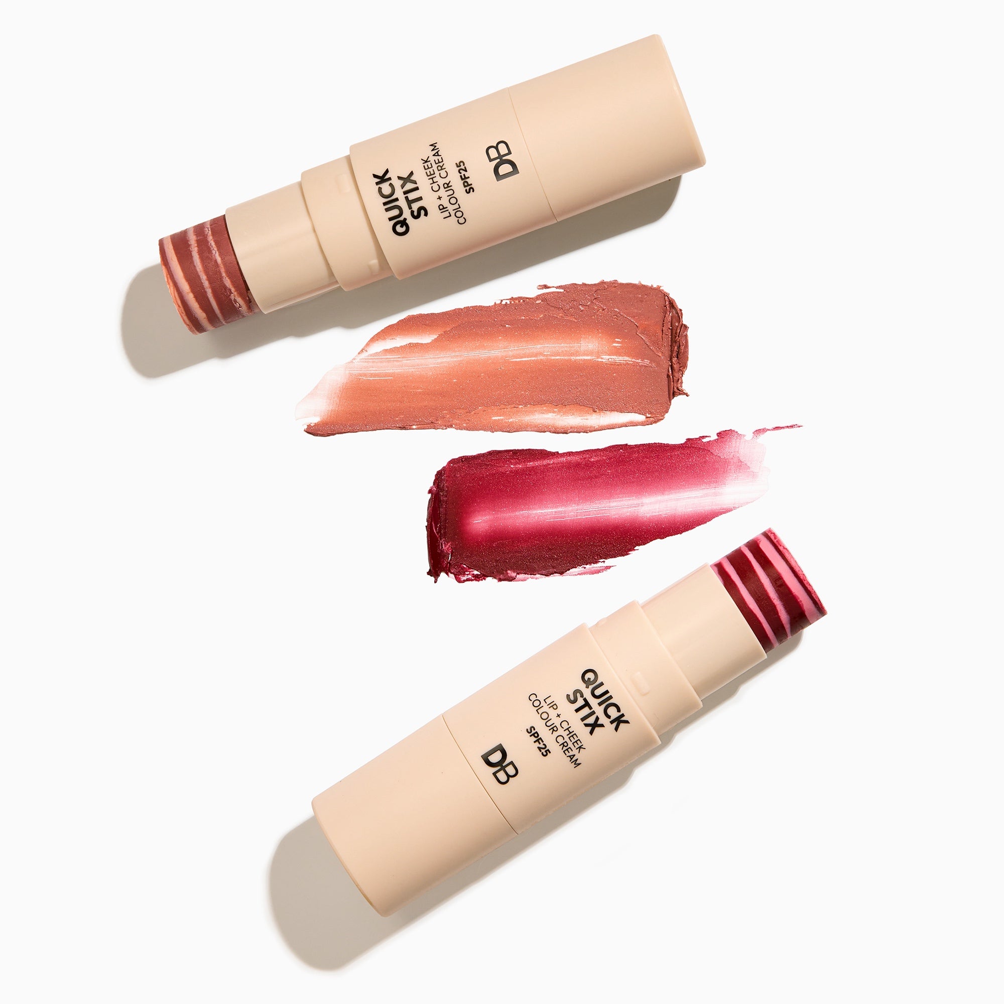 Two cosmetic sticks with swatches of color on a white background