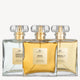Three Designer Brands perfumes, Summer Garden, Koko, and Briella, with elegant gold-accented caps, displayed in a row.