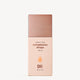 A bottle of "Complexion Drops" with SPF 25, featuring a sleek rose-toned cap and minimalist design. Text highlights "Barely There" formula.